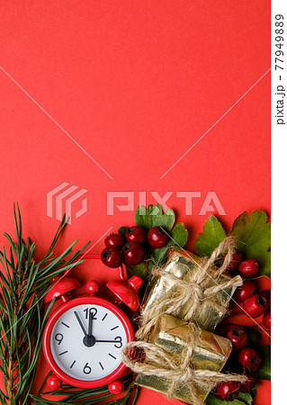 Christmas gifts, alarm, berries hawthorn, pine branch on background with copy space. Christmas gifts, alarm, berries hawthorn, pine branch on background with copy space. 77949889