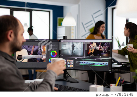 Videographer editing movie project drinking coffee using post production software Videographer editing movie project drinking coffee using post production software 77951249