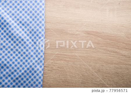 Checkered blue napkin on wooden background. Checkered blue napkin on wooden background. 77956571