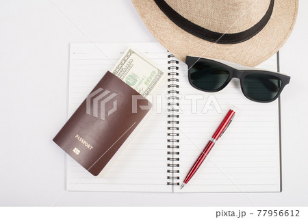 Passports,hat, camera ,glasses, pen on a paper floor ready to travel. 77956612
