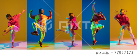 Young girl and man dancing hip-hop in bright attire on colorful background in neon light Young girl and man dancing hip-hop in bright attire on colorful background in neon light 77957173