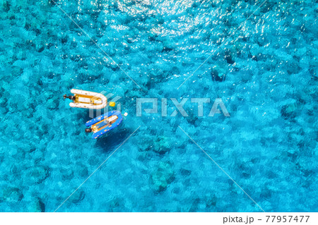 Aerial view of the boat in clear blue water at sunny day 77957477