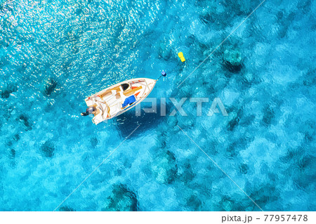 Aerial view of the boat in clear blue water at sunny day 77957478