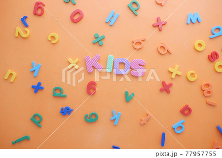 colorful plastic letters on orange background, Top view  77957755