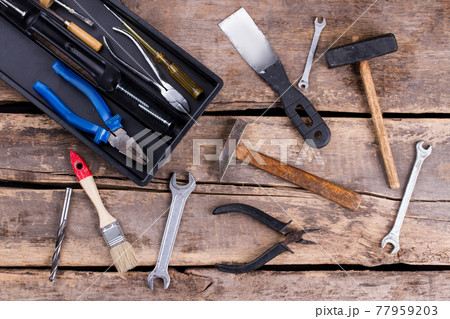 Vintage hand tools on rustic background. 77959203