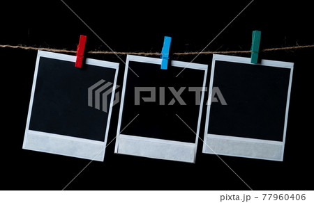 Blank square photo frames hanging on a clothesline 77960406