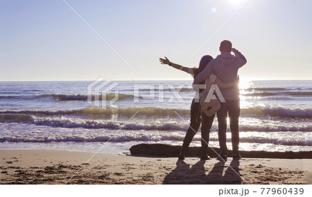 Happy family enjoying sunset in the summer leisure. Concept of friendly family. The couple relax Happy family enjoying sunset in the summer leisure. Concept of friendly family. The couple relax 77960439