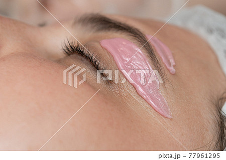 Hand of cosmetologist applying wax paste on armpit. 77961295