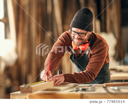 Joiner making marks on wooden detail 77965014