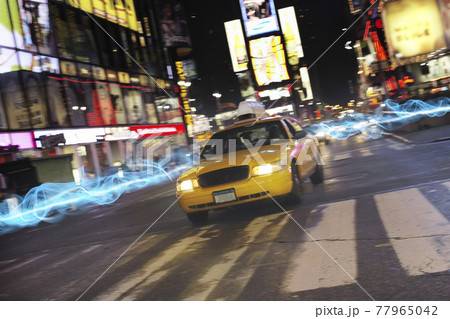 Taxi on city street at night 77965042