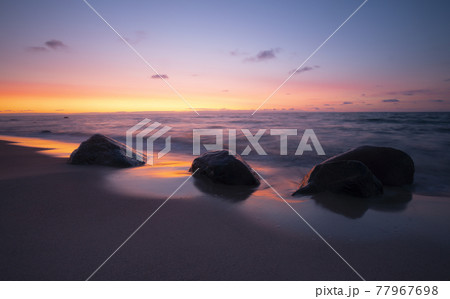 Beautiful sunset at the beach of a national park in sweden after a summers day Beautiful sunset at the beach of a national park in sweden after a summers day 77967698