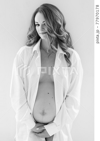 beautiful pregnant woman in white shirt. the beauty of the female body. beautiful pregnant woman in white shirt. the beauty of the female body. 77970178