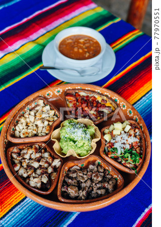 mexican plate with different meat and guacamole. 77970551