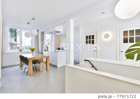 Open kitchen with dining table 77971722