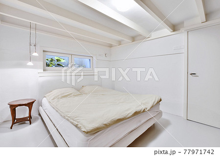 Simple minimalist bedroom with small window 77971742