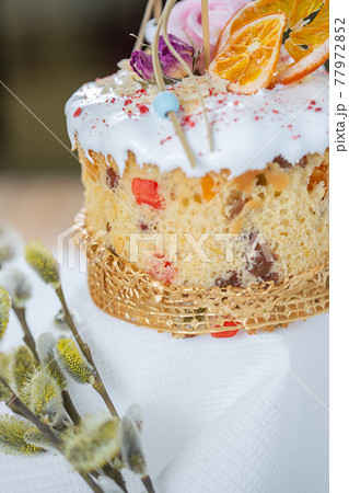 Close-up of an Easter cake. Dried oranges and roses on top of the cake Close-up of an Easter cake. Dried oranges and roses on top of the cake 77972852