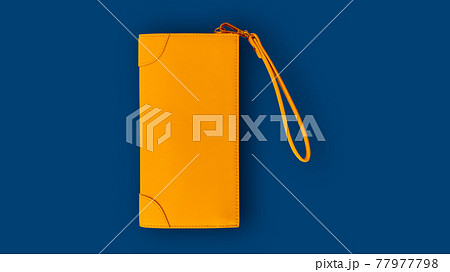Top view of a yellow lady wallet on a blue background. Top view of a yellow lady wallet on a blue background. 77977798