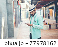 Hipster man listening music with his smartphone on the street in urban. 77978162