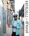Hipster man listening music with his smartphone on the street in urban. 77978164