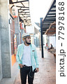 Hipster man listening music with his smartphone on the street in urban. 77978168