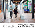 Young couple walking together on urban street. Couple in love concept. 77978173