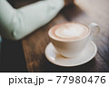 Man with coffee cup in cafe. 77980476