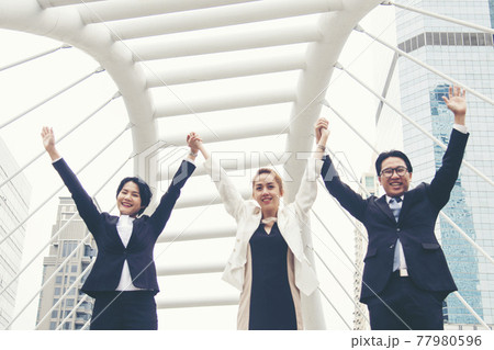 Teamwork Together Concept. Group of diversity people high five on air to greeting power of tag team. Multiethnic people group working togetherness. Volunteer collaboration in Business Team success 77980596