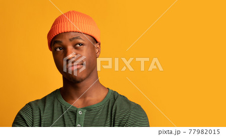 Doubtful Black Hipster Guy Looking Aside At Copy Space With Disbelief Doubtful Black Hipster Guy Looking Aside At Copy Space With Disbelief 77982015