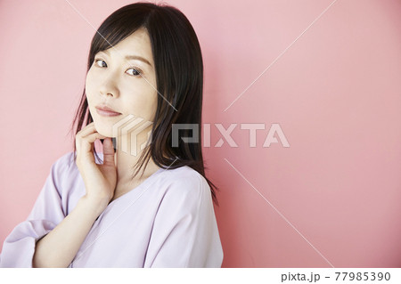 Beautiful asian woman on pink background 77985390