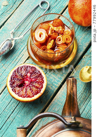 Orange jam in a glass jar on wooden table 77992446