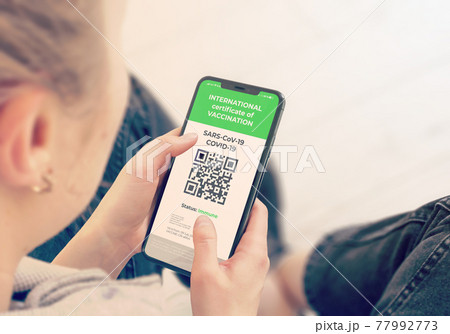 COVID-19: Digital green certificates on Cellphone Screen. COVID-19: Digital green certificates on Cellphone Screen. 77992773