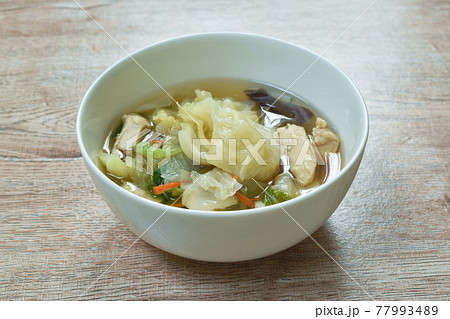 boiled cabbage and mixed vegetable with chicken soup on bowl 77993489