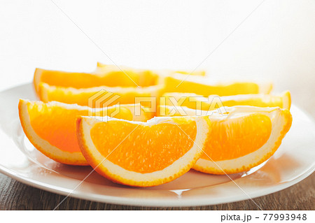 fresh orange slices on a plate 77993948