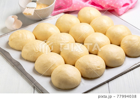 Sweet yeast buns before baking. Sweet yeast buns before baking. 77994038