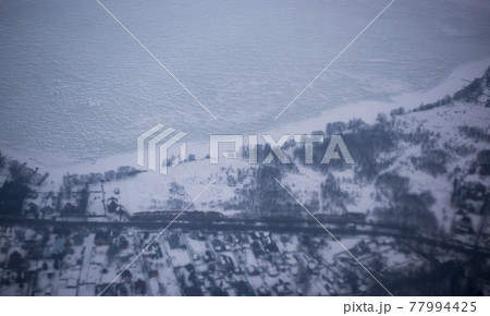 View of the snow-covered suburbs of Moscow from an airplane View of the snow-covered suburbs of Moscow from an airplane 77994425