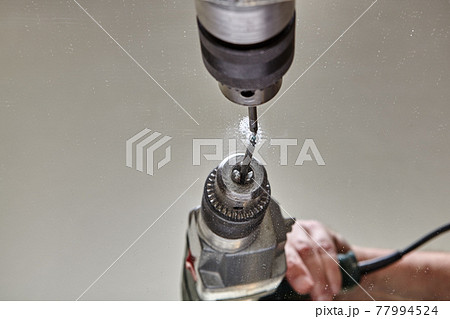 Drilling hole in glass or mirror with special drill bit. 77994524