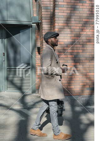 African man walking on the street 77995010