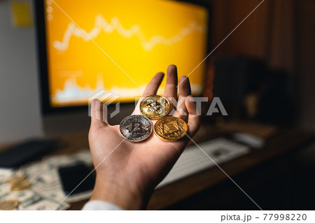 Cryptocurrencies Concept The crypto in hand at the desk 77998220
