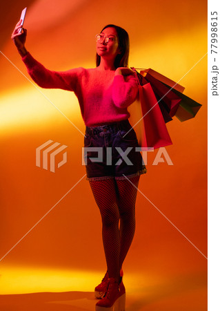cyber monday shopping neon color light girl selfie 77998615