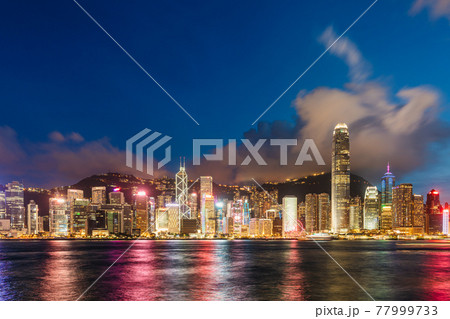 Hong Kong downtown skyline across Victoria harbor at night, Hong Kong, China. 77999733