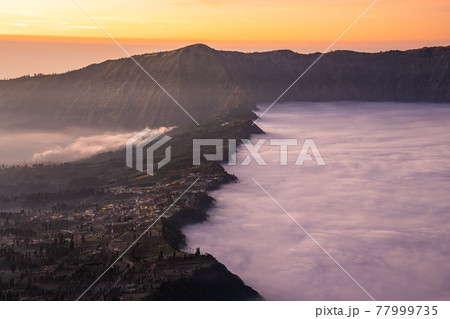 Beautiful sunrise with sea of fog at Cemoro Lawang village at mount Bromo volcano in, East Java, Indonesia 77999735