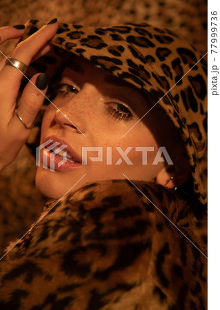 Girl with freckled skin posing while touching with her hand fields from her panama 77999736