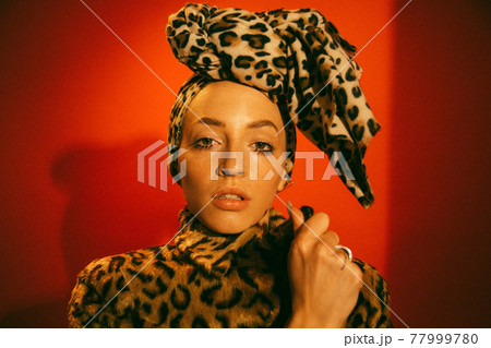Woman wearing leopard look standing in front of the camera with open mouth 77999780