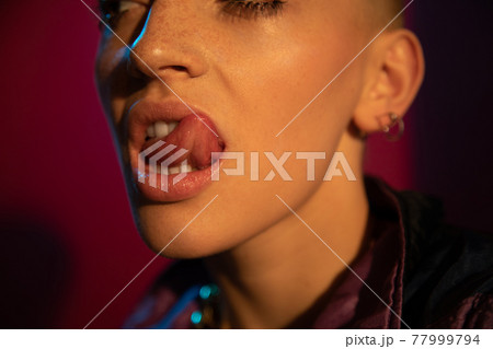 Short haired impudent woman with freckled skin showing her tongue Short haired impudent woman with freckled skin showing her tongue 77999794