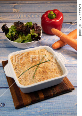 Salmon Parmentier recipe with hazelnuts, young salad leaves 77999924