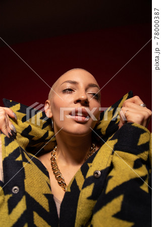 Woman with nude make up looking away and closing neck with collar Woman with nude make up looking away and closing neck with collar 78000387