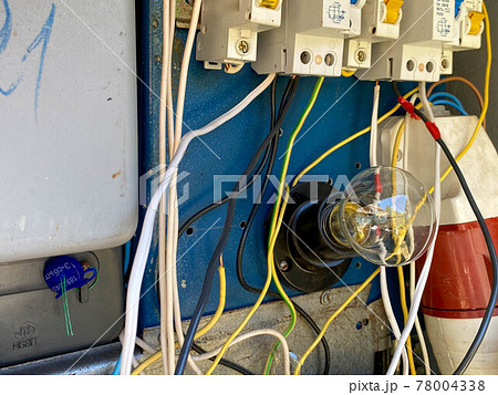 A light bulb in a homemade electric control cabinet for electronic devices with circuit breakers and counters in an iron box A light bulb in a homemade electric control cabinet for electronic devices with circuit breakers and counters in an iron box 78004338
