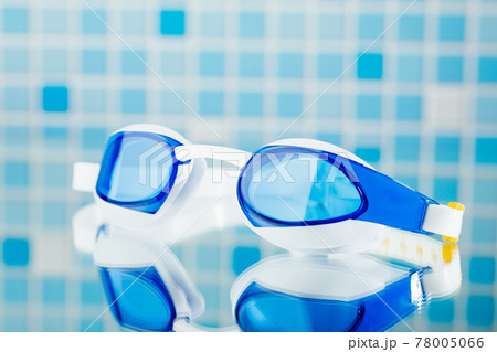 professional swimming glasses for training or competition, blue tile background professional swimming glasses for training or competition, blue tile background 78005066