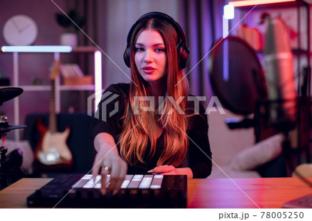 Woman working on dj controller for making modern music Woman working on dj controller for making modern music 78005250