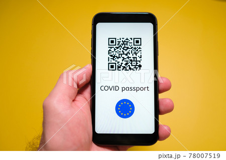 A smartphone with electronic immune digital health passport, Covid pass with QR code in mans hand on the yellow background. A smartphone with electronic immune digital health passport, Covid pass with QR code in mans hand on the yellow background. 78007519